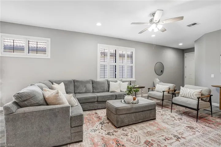 Living room featuring a ceiling fan, plenty of natural light, recessed lighting, baseboards, and light wood-style floors