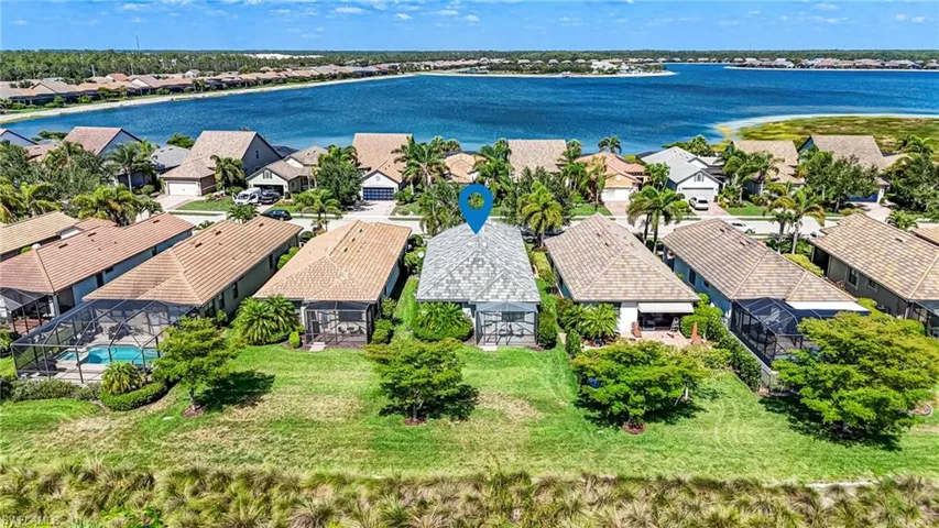 Aerial view of residential area featuring a large body of water