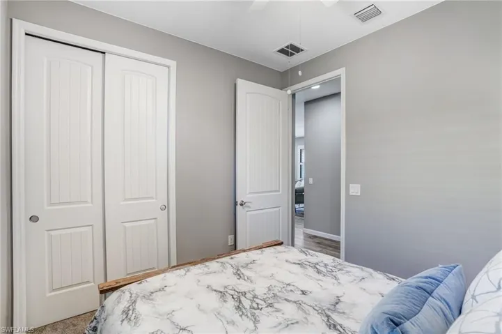 Bedroom with a closet, a ceiling fan, and baseboards