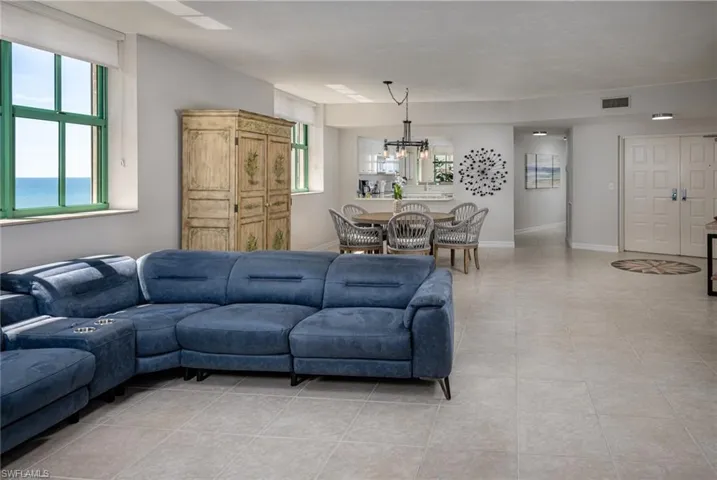 Living room with a chandelier and light tile patterned flooring