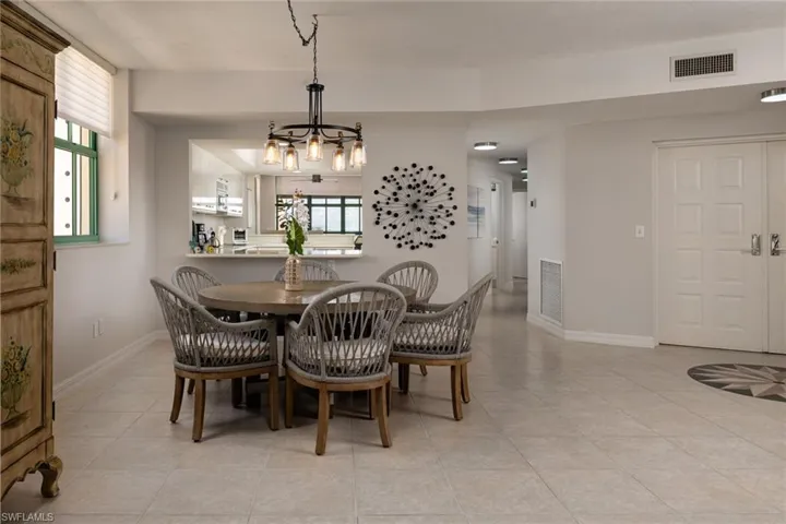 Dining room featuring suspended lighting and light tile patterned flooring