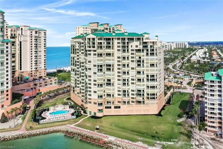 View of apartment building / complex with a water view and a view of city