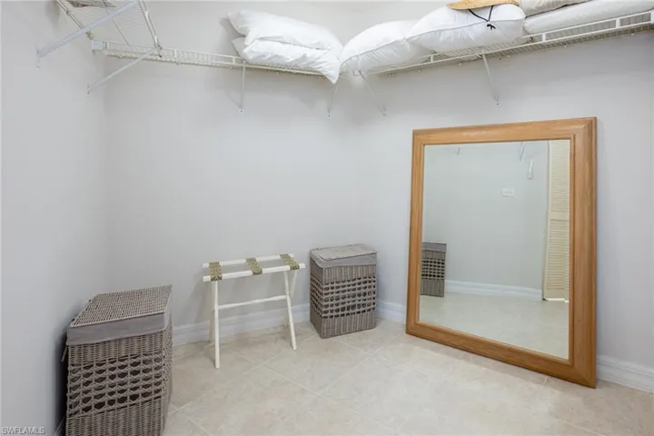 Walk in closet with light tile patterned floors