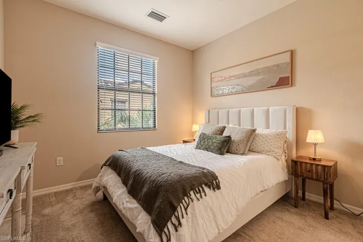 Bedroom featuring light colored carpet