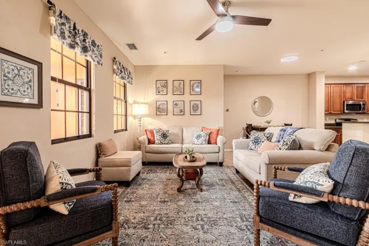 Tiled living room with french doors and ceiling fan