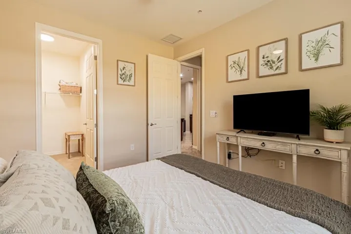 Bedroom featuring carpet flooring, a closet, and a spacious closet