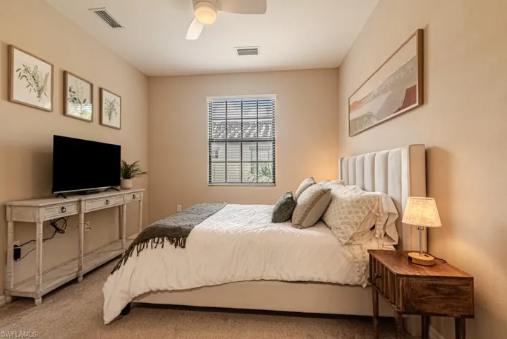 Carpeted bedroom with ceiling fan