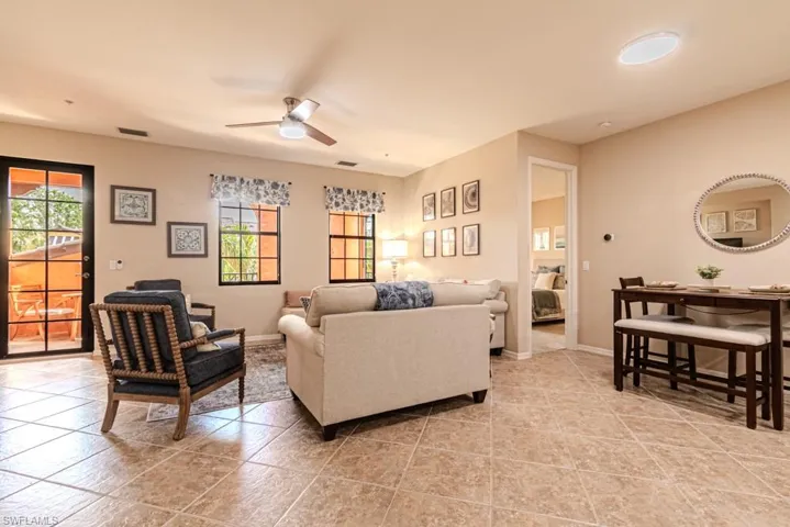 Living room featuring ceiling fan and light tile patterned floors