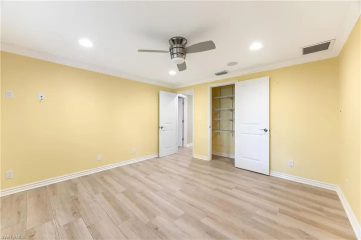 Unfurnished bedroom with ornamental molding, recessed lighting, light wood finished floors, and ceiling fan