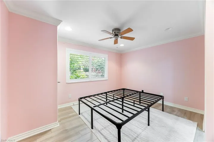Bedroom featuring ornamental molding, light wood-style flooring, recessed lighting, and a ceiling fan