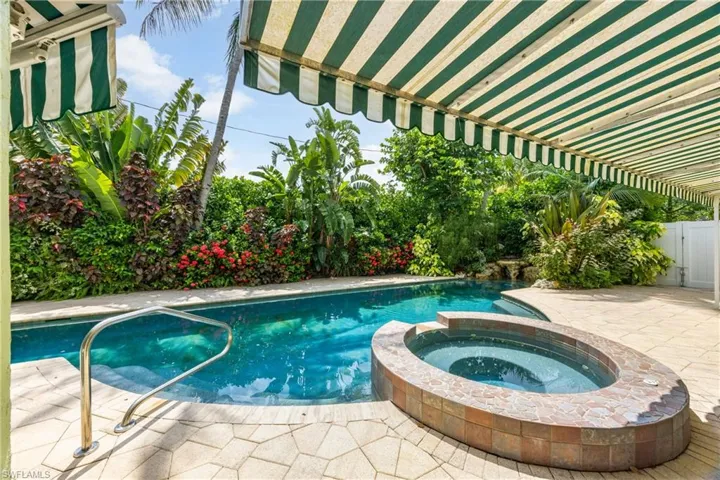 View of swimming pool featuring a patio and a pool with connected hot tub