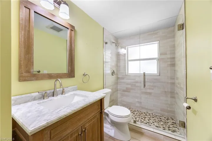 Bathroom with vanity and a shower stall