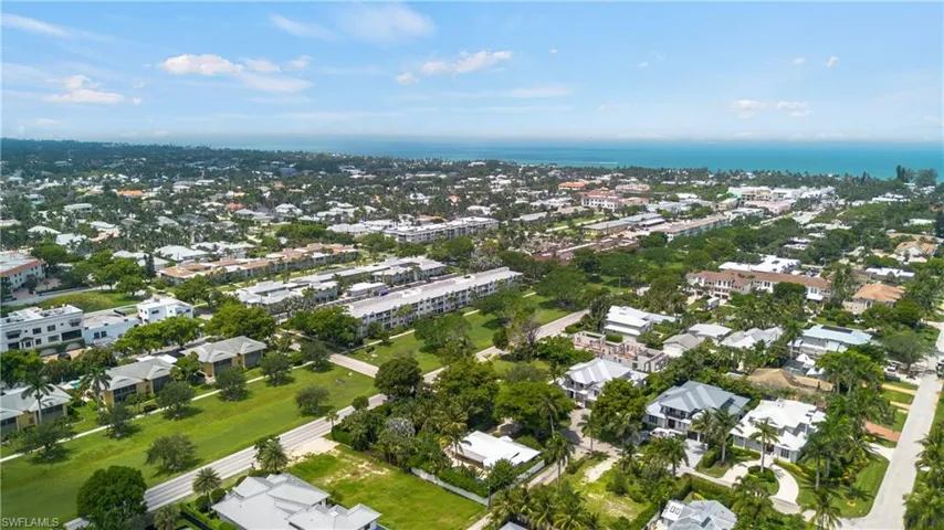 Aerial view of property and surrounding area with a large body of water