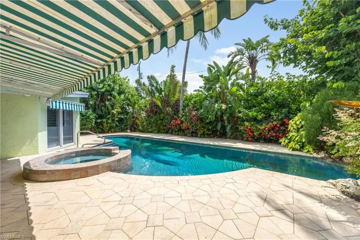 View of swimming pool featuring a patio area and a pool with connected hot tub