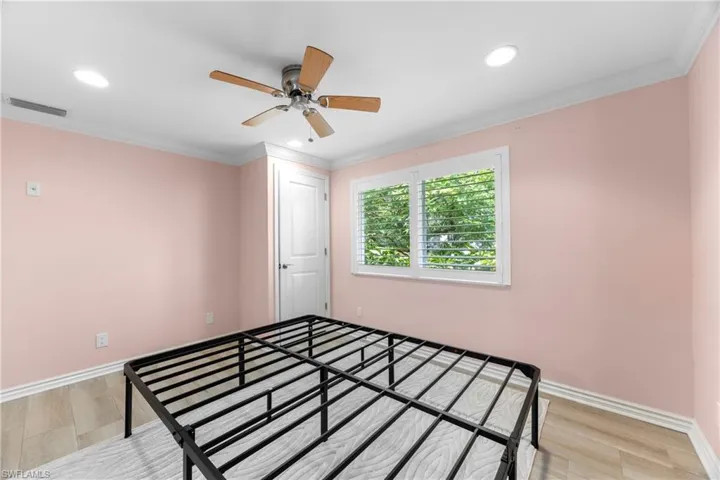 Unfurnished bedroom featuring recessed lighting, light wood-type flooring, crown molding, and a ceiling fan