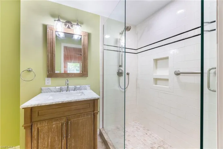 Full bathroom with a shower stall and vanity