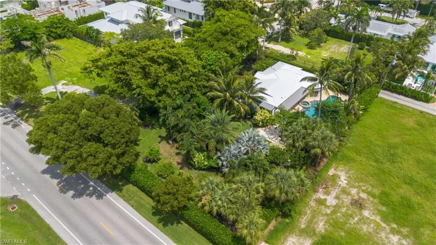 View of property location with a pool and nearby suburban area