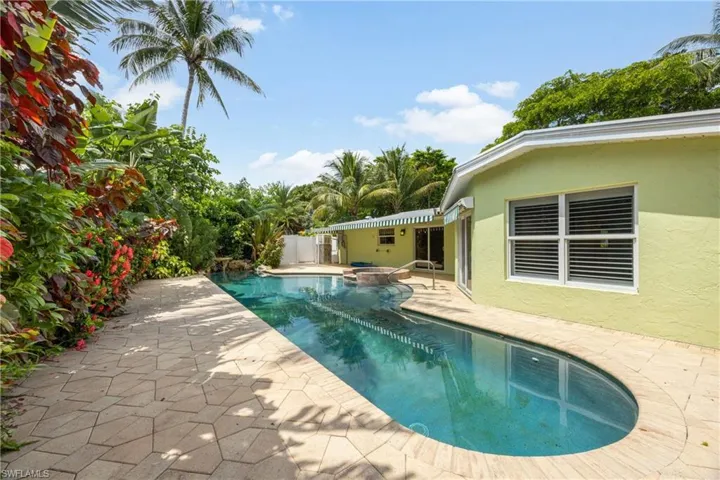 Swimming pool featuring an in-ground hot tub and a patio area