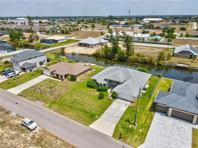 Drone / aerial view with a residential view and a water view