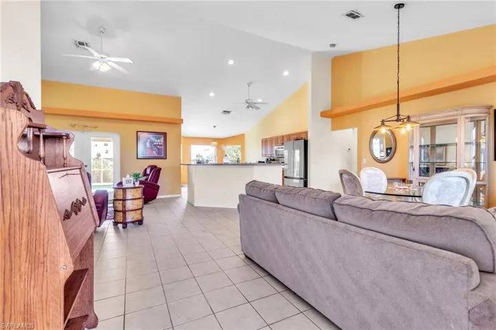 Living room featuring plenty of natural light, ceiling fan, and light tile patterned floors