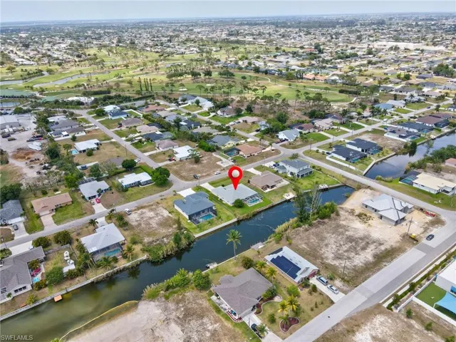 Birds eye view of property featuring a water view and a residential view