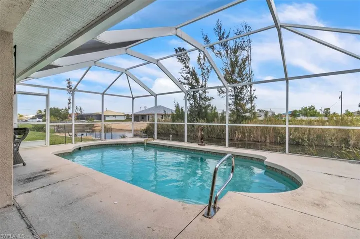 Pool with glass enclosure and a patio