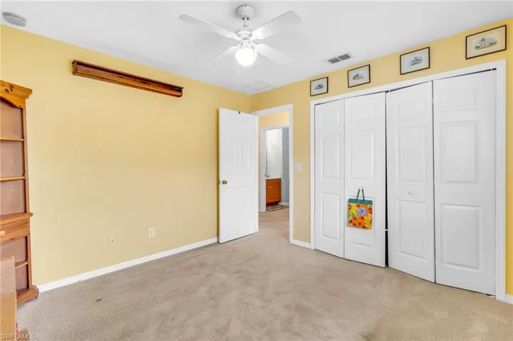 Unfurnished bedroom featuring baseboards, visible vents, a closet, and light colored carpet