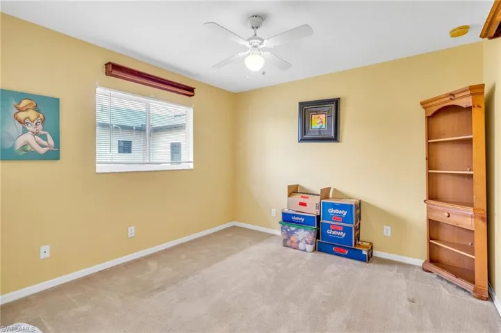 Recreation room with a ceiling fan, baseboards, and carpet