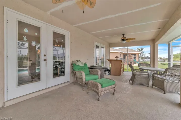 View of patio / terrace featuring french doors, outdoor dining space, and ceiling fan