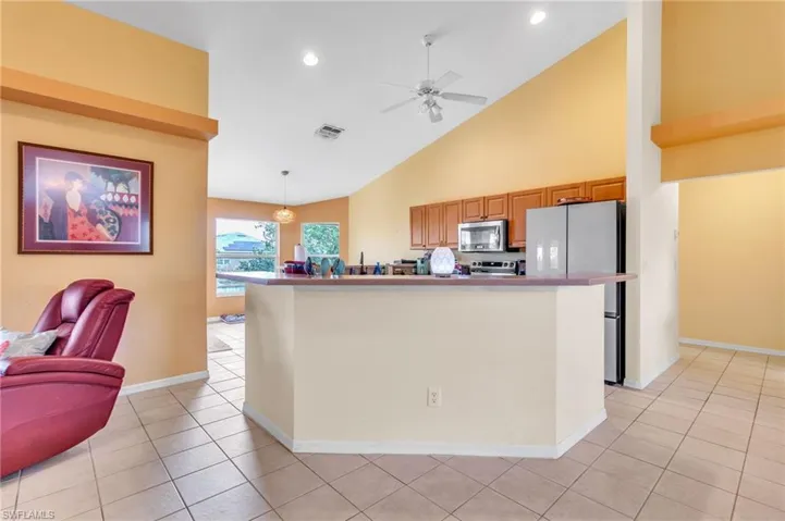 Kitchen with a ceiling fan, appliances with stainless steel finishes, visible vents, and light tile patterned floors