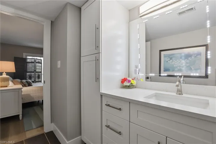 Ensuite bathroom featuring vanity and baseboards