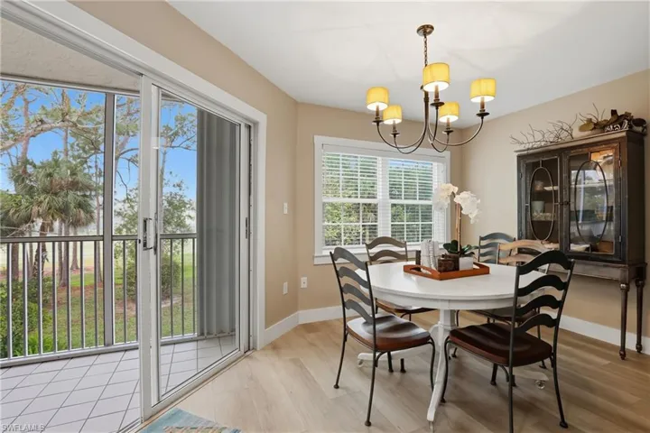 Dining space with suspended lighting and light wood-style flooring