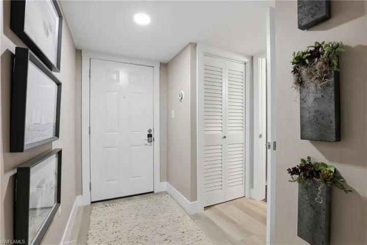 Foyer with light wood-style floors and baseboards
