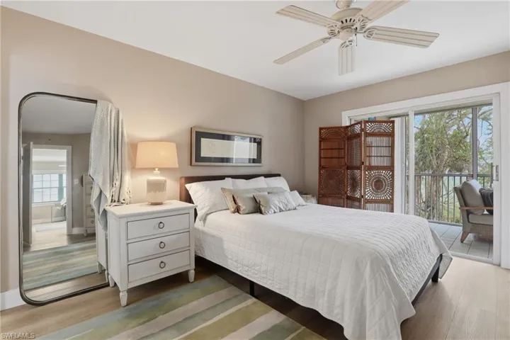 Bedroom featuring access to outside, light wood finished floors, and a ceiling fan