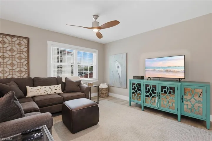 Living room with ceiling fan and light wood-type flooring