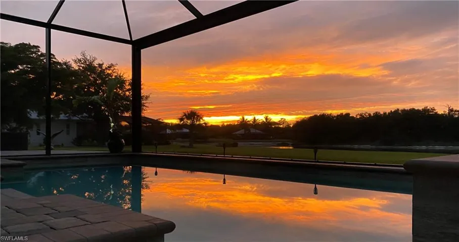 Pool at dusk with a lanai