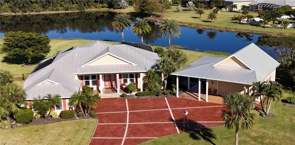 View of front of property with a porch and a water view