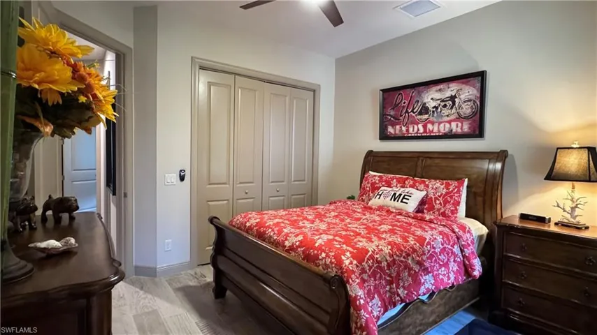 Bedroom with ceiling fan and a closet
