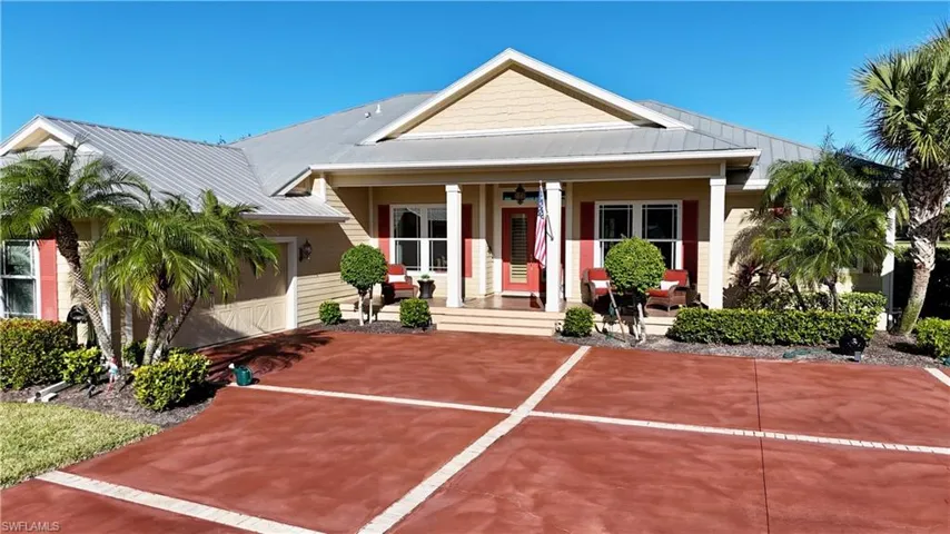 View of front facade with covered porch and a garage
