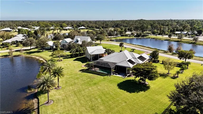 Birds eye view of property with a water view