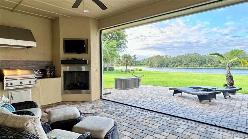 View of patio with ceiling fan, a grill, and exterior kitchen