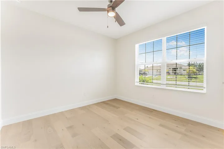 Spare room featuring light wood finished floors and ceiling fan