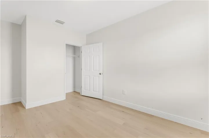 Unfurnished bedroom with light wood finished floors and a closet