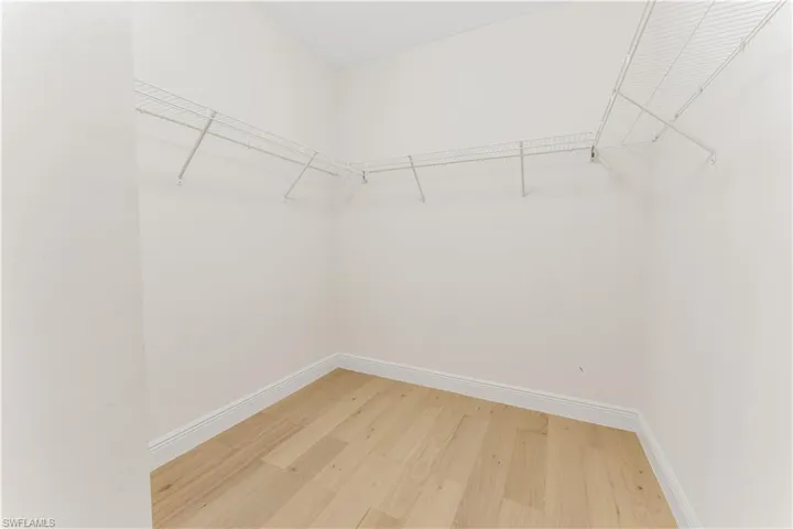 Walk in closet featuring light wood-type flooring