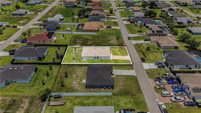 Aerial view of property's location featuring nearby suburban area