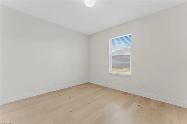 Empty room featuring light wood finished floors and baseboards