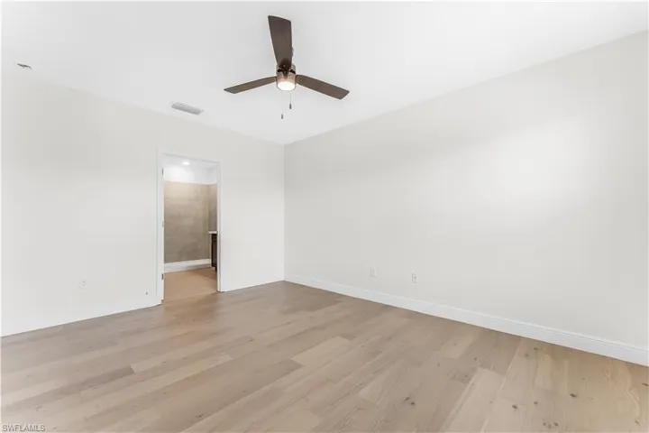 Unfurnished room with ceiling fan and light wood finished floors