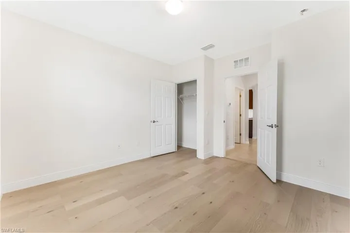 Unfurnished bedroom with light wood-type flooring and a closet