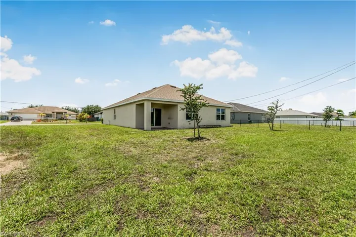 Rear view of property featuring stucco siding