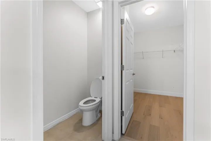 Bathroom with toilet and wood finished floors